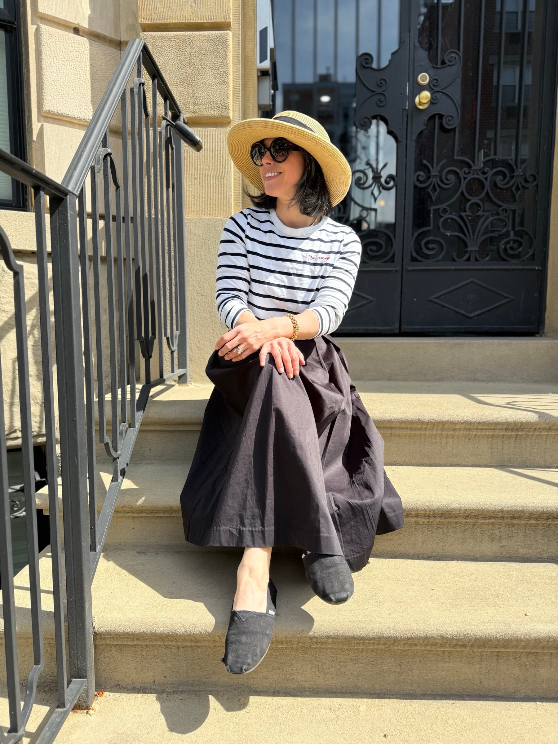 Maddy sitting on a stoop