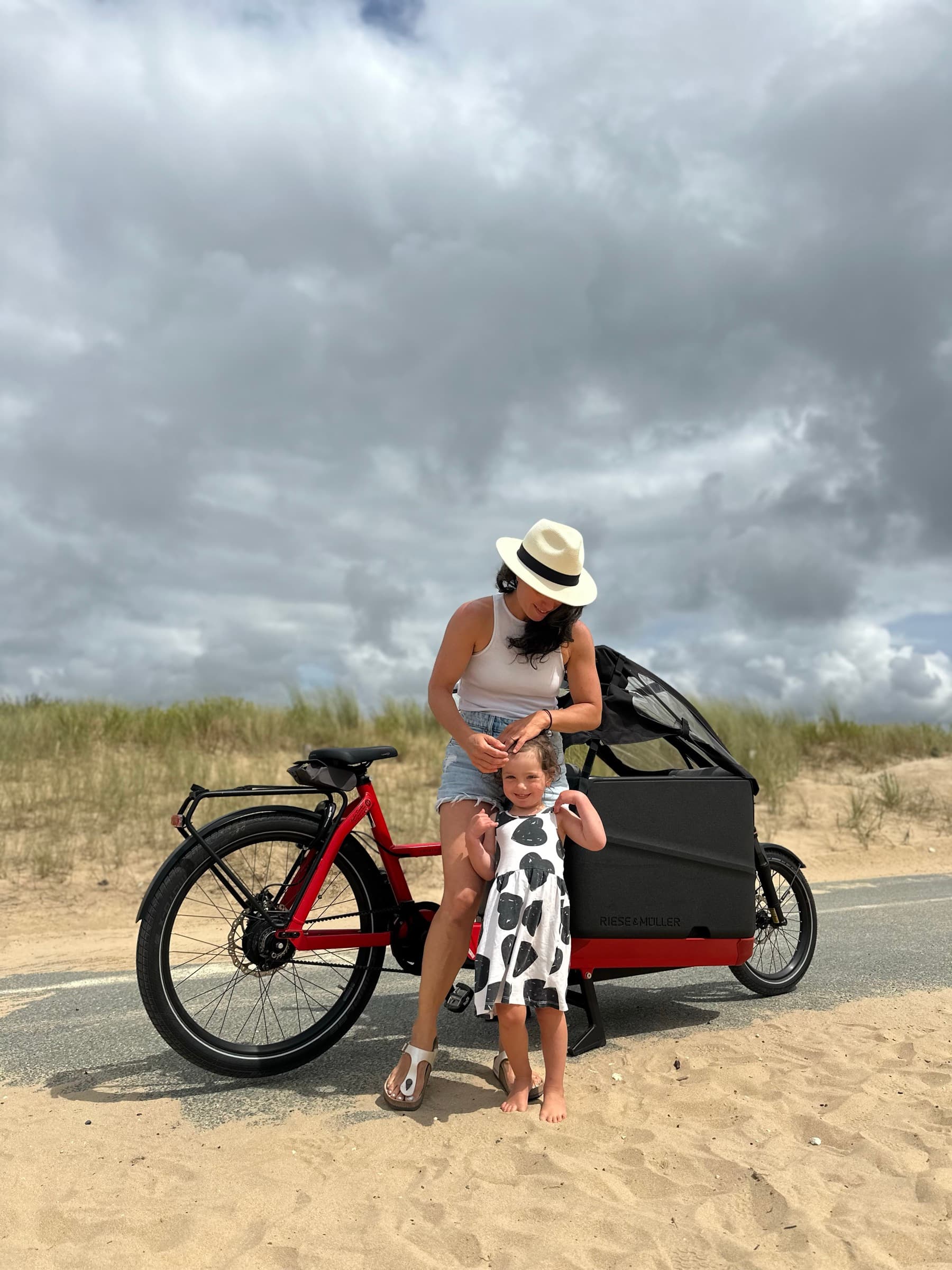 Maddy and one of her kids with a cargo bike on the beach